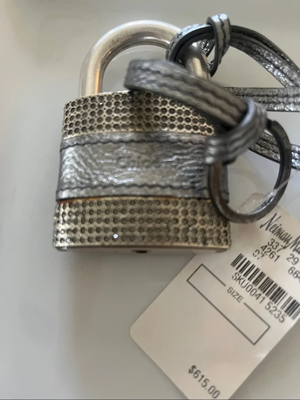 : Chloé • Padlock & key • Metallic leather strap • Textured metal detailing •